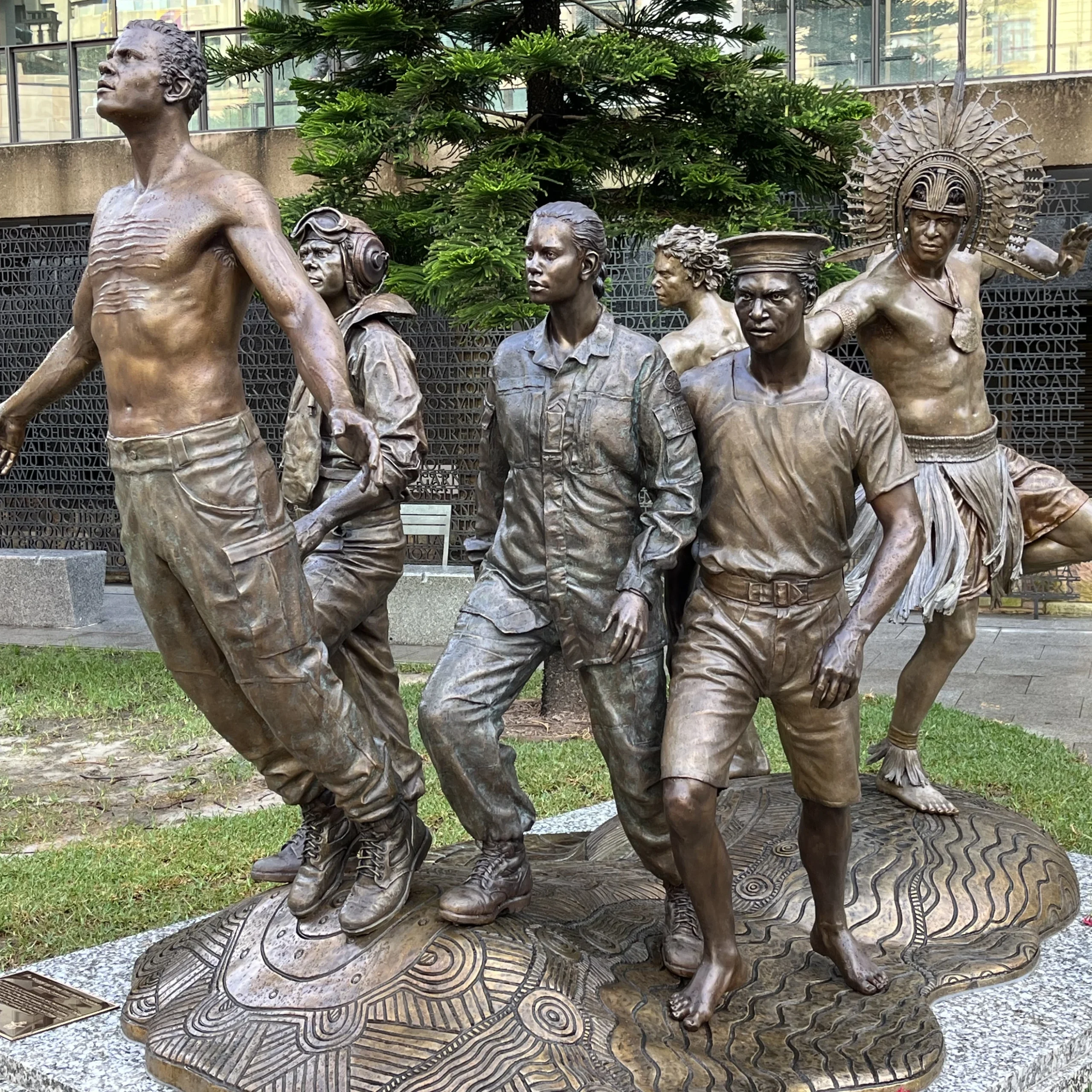 Bespoke Bronze Memorial showcasing six diverse figures: a shirtless man, pilot, soldier, sailor, nurse, and an Indigenous person. Symbol of unity and remembrance.